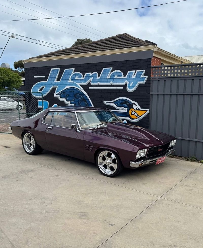 Customer's classic Holden coupe parked in front of the Henley mural